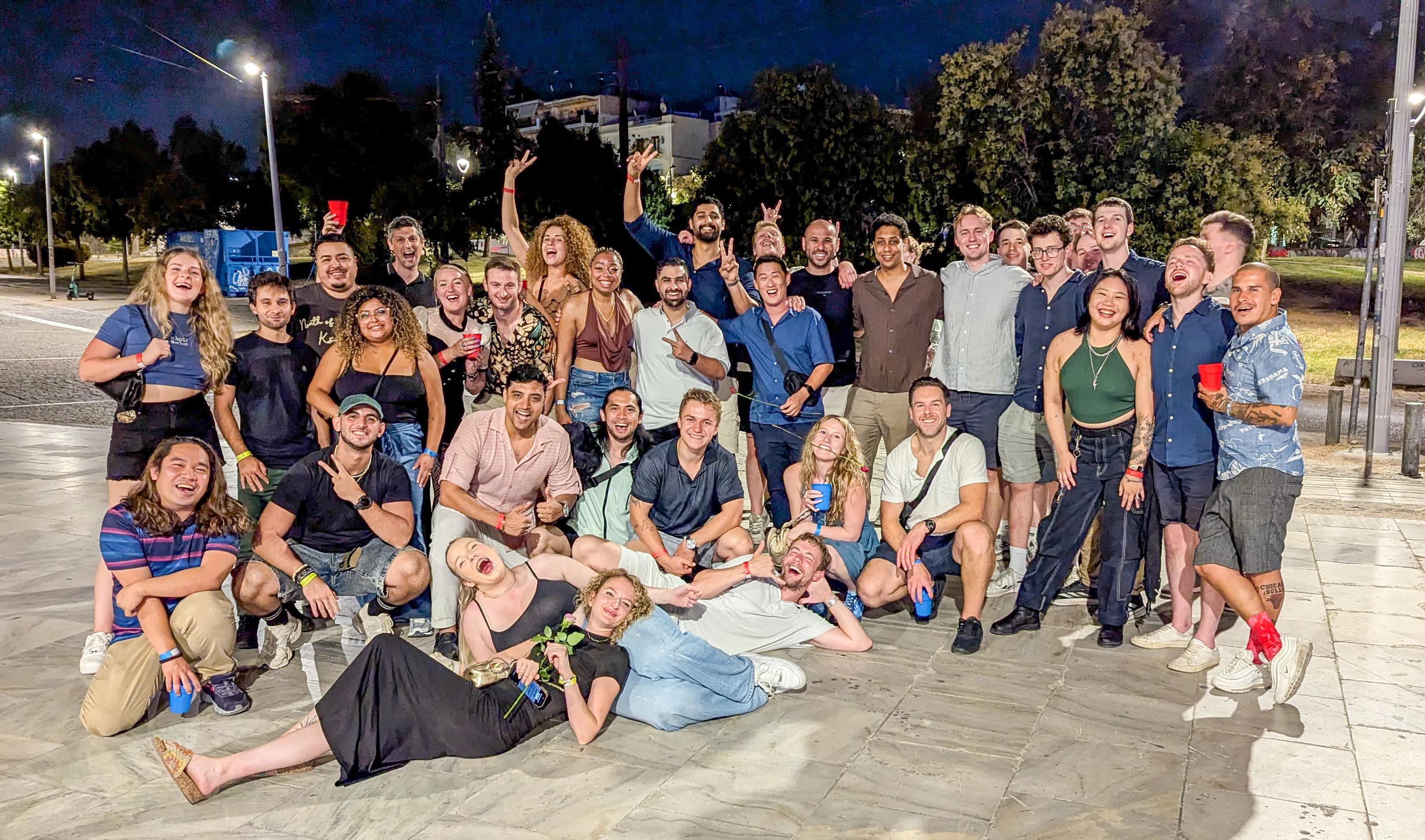 International friends socializing at premium venue during Athens pub crawl premium service athens bar crawl experience